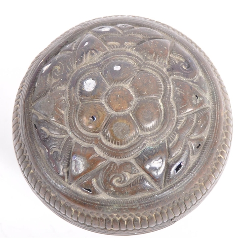 141 - A large Indonesian cast brass lime container. A spherical brass box, cast in two halves, decorated i... 