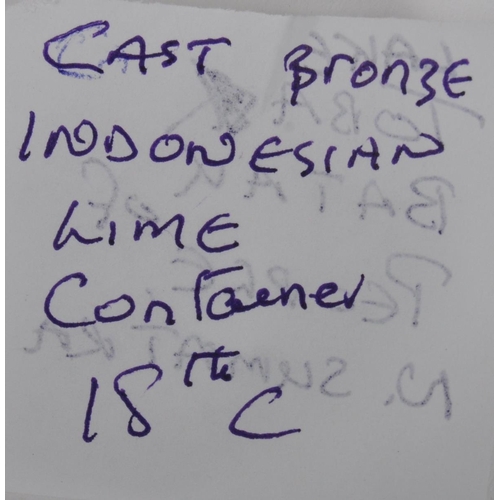 141 - A large Indonesian cast brass lime container. A spherical brass box, cast in two halves, decorated i... 