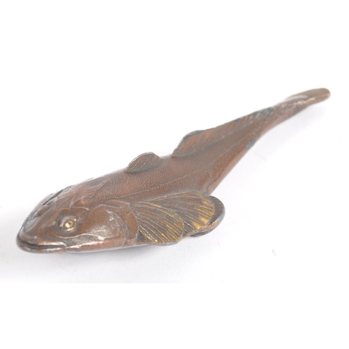 145 - An early 20th century Japanese bronze scroll weight. A Meiji period bronze in the form of a carp wit... 