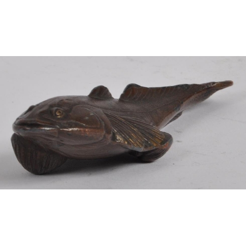 145 - An early 20th century Japanese bronze scroll weight. A Meiji period bronze in the form of a carp wit... 