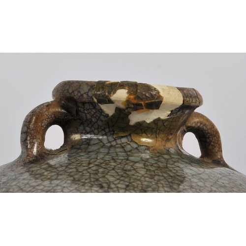 146 - A 15th century Chinese Ming dynasty celadon jar / jug. With short everted neck and twin lug handles ... 