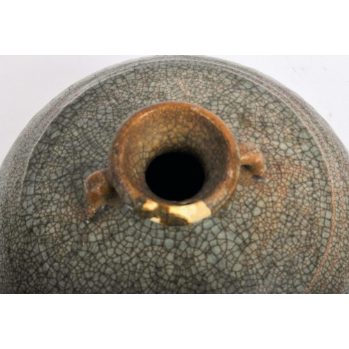 146 - A 15th century Chinese Ming dynasty celadon jar / jug. With short everted neck and twin lug handles ... 