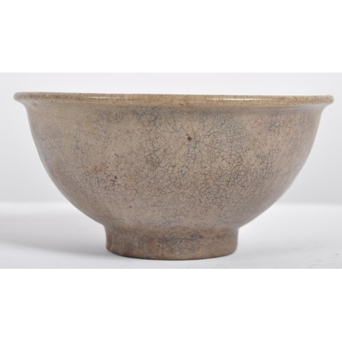 147 - A 15th century Chinese Ming Dynasty celadon bowl. With raised lips on a circular foot, with crackled... 