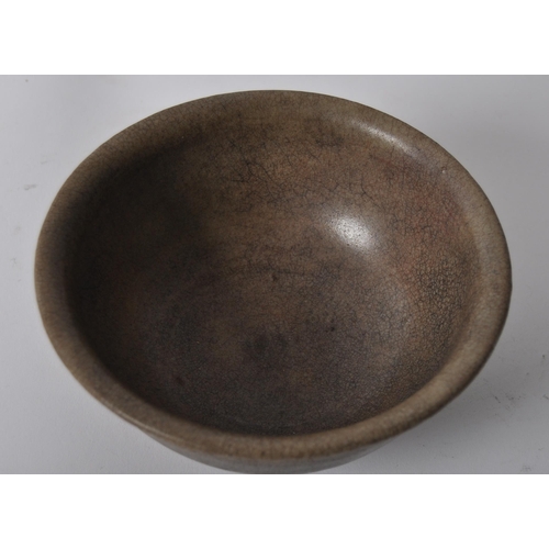 147 - A 15th century Chinese Ming Dynasty celadon bowl. With raised lips on a circular foot, with crackled... 