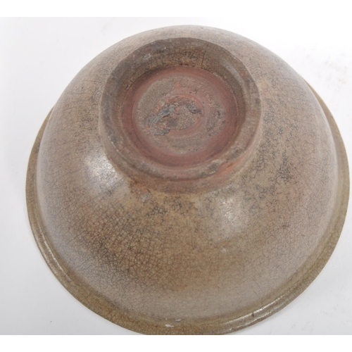 147 - A 15th century Chinese Ming Dynasty celadon bowl. With raised lips on a circular foot, with crackled... 