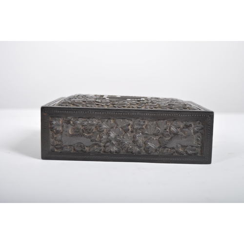 148 - A 19th century Anglo Indian hand carved wooden trinket Box. Black hardwood of square form intricatel... 