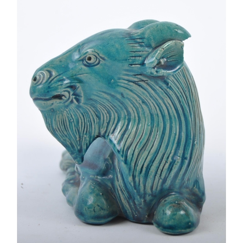 161 - A 19th Century Chinese monochrome pottery figurine depicting a Zodiac goat. Modelled reclined with e... 