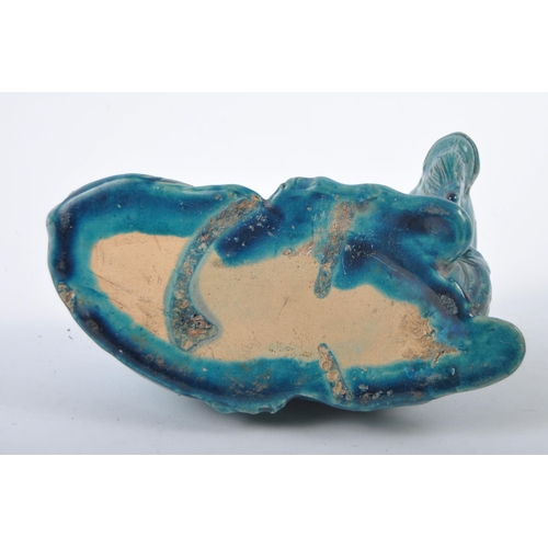 161 - A 19th Century Chinese monochrome pottery figurine depicting a Zodiac goat. Modelled reclined with e... 