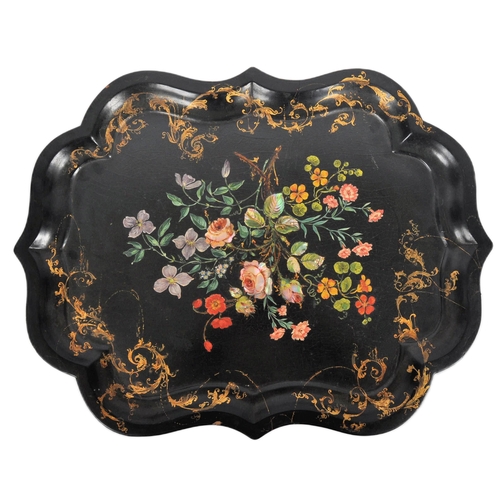168 - An 18th Century Chinese black lacquer export papier mache tray of scalloped form. Central painted fl... 