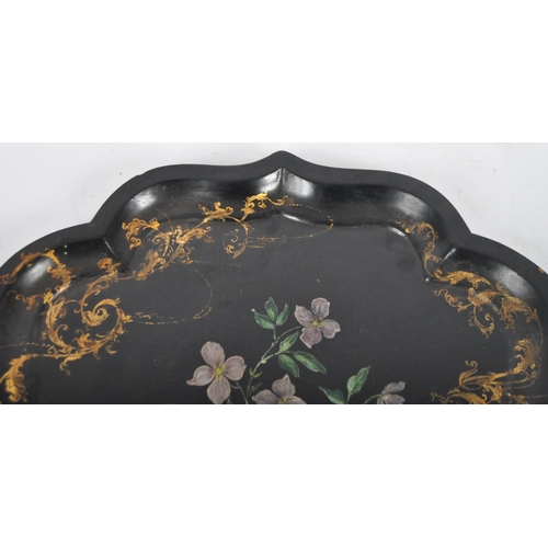 168 - An 18th Century Chinese black lacquer export papier mache tray of scalloped form. Central painted fl... 