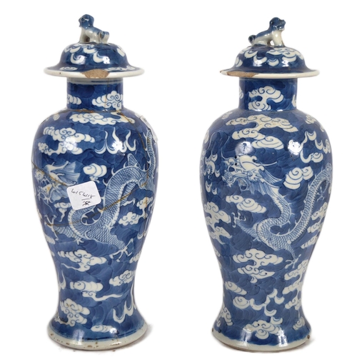 169 - A pair of 19th Century Chinese Kangxi mark blue & white porcelain vases and covers. Foo dog finial t... 