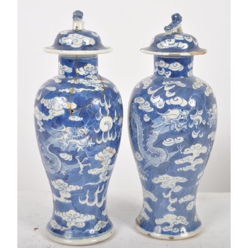 169 - A pair of 19th Century Chinese Kangxi mark blue & white porcelain vases and covers. Foo dog finial t... 