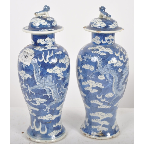 169 - A pair of 19th Century Chinese Kangxi mark blue & white porcelain vases and covers. Foo dog finial t... 