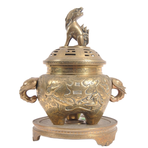 171 - A Chinese twin handled bronze incense burner.   With asynchronous floral décor to surround, depictin... 