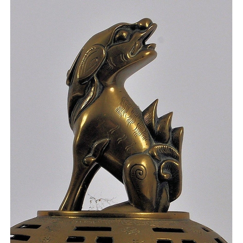 171 - A Chinese twin handled bronze incense burner.   With asynchronous floral décor to surround, depictin... 