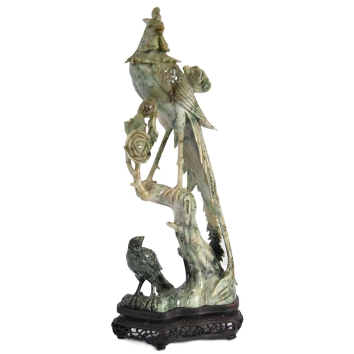 172 - An early 20th Century Chinese large carved jade figurine depicting a cockerel / rooster standing on ... 