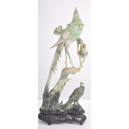 172 - An early 20th Century Chinese large carved jade figurine depicting a cockerel / rooster standing on ... 