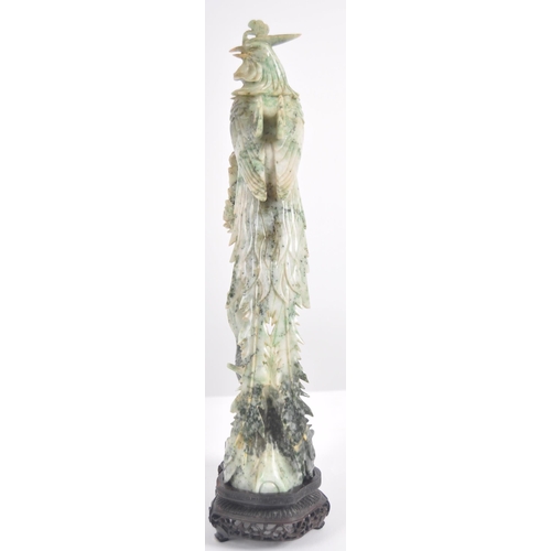 172 - An early 20th Century Chinese large carved jade figurine depicting a cockerel / rooster standing on ... 