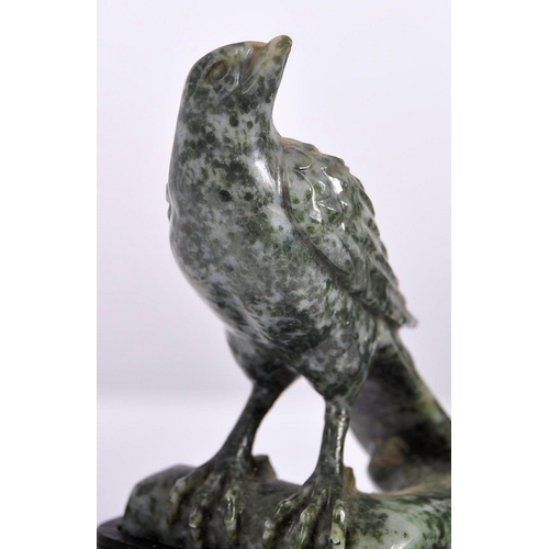 172 - An early 20th Century Chinese large carved jade figurine depicting a cockerel / rooster standing on ... 