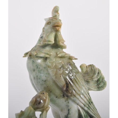 172 - An early 20th Century Chinese large carved jade figurine depicting a cockerel / rooster standing on ... 