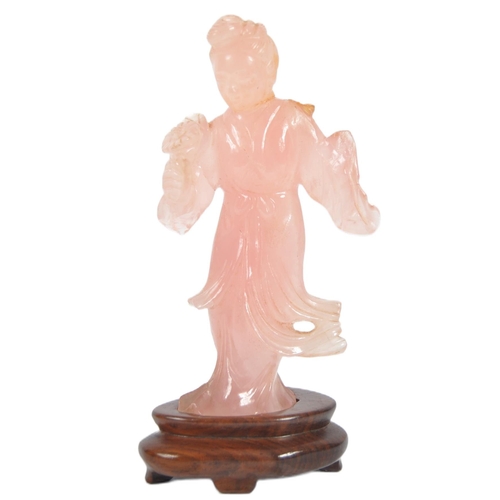 173 - A Chinese carved pink quartz figurine depicting Guanyin. Hand carved pink quartz figure raised on ca... 