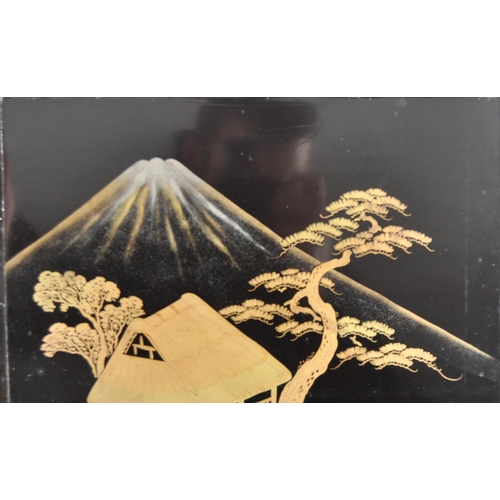 175 - A 19th Century Japanese black lacquer box. Hand painted decoration throughout depicting landscape sc... 