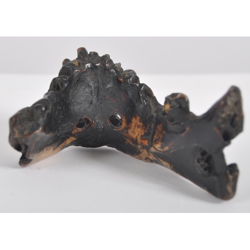 178 - A 19th century Nepalese witch doctors amulet. In the form of a human lower jaw, of charred and lacqu... 