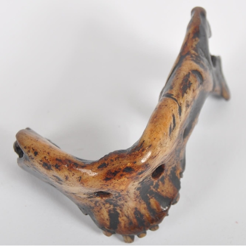 178 - A 19th century Nepalese witch doctors amulet. In the form of a human lower jaw, of charred and lacqu... 