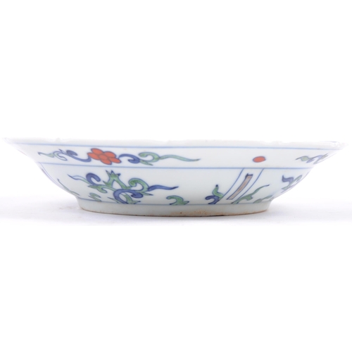 38 - A 20th century Ming dynasty marked to base porcelain bowl / plate, decorated with carps and floral m... 