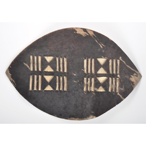 55 - A 19th Century African Tribal Zulu war shield. Hide construction and of typical form with pierced se... 