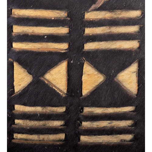 55 - A 19th Century African Tribal Zulu war shield. Hide construction and of typical form with pierced se... 