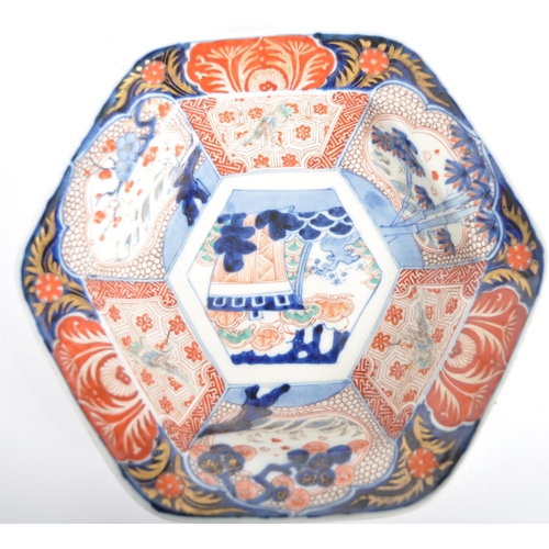 59 - A Japanese 19th century Meiji Period large Imari hexagonal centrepiece bowl. The bowl depicting trad... 