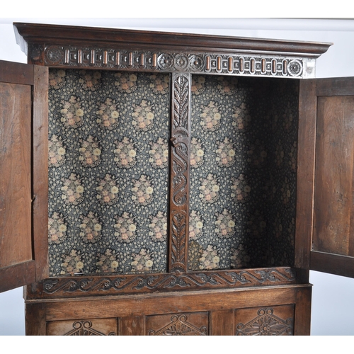 10 - A large 18th Century carved oak hall / livery cupboard armoire wardrobe. Flared carved cornice top w... 