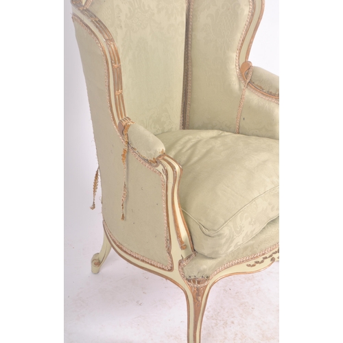 108 - A 19th Century French painted fauteuil wingback armchair. Carved shell back rail with cushioned back... 