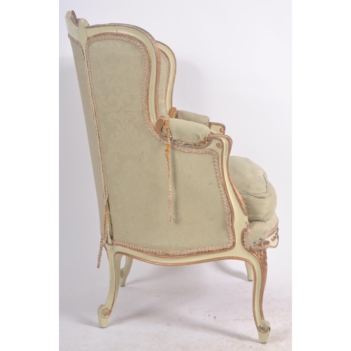 108 - A 19th Century French painted fauteuil wingback armchair. Carved shell back rail with cushioned back... 