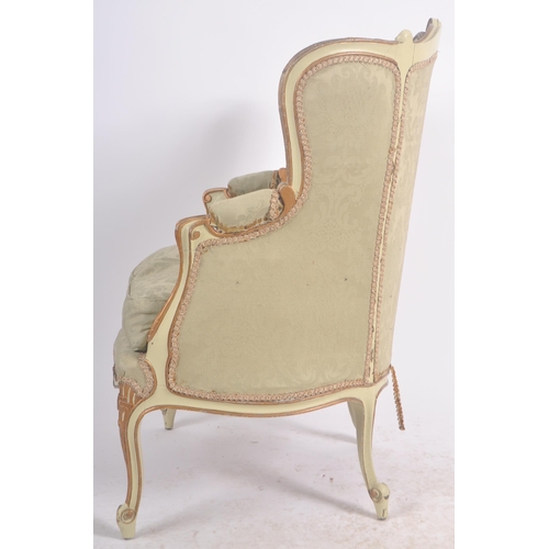 108 - A 19th Century French painted fauteuil wingback armchair. Carved shell back rail with cushioned back... 