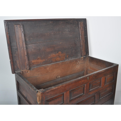 113 - An 18th Century George III oak mule chest coffer blanket box. Geometric block panelled front with tw... 