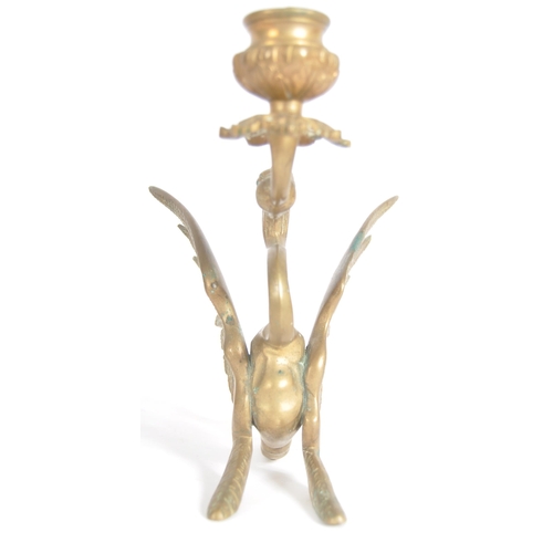 114 - A pair of 19th Century brass candlesticks in the form of mythical griffins. Both with candle sconce ... 