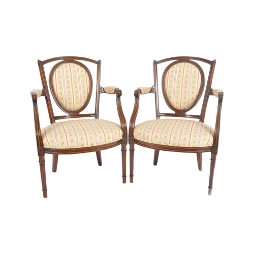 118 - A pair of 20th Century Edwardian mahogany armchairs / armchairs having carved show wood frames with ... 