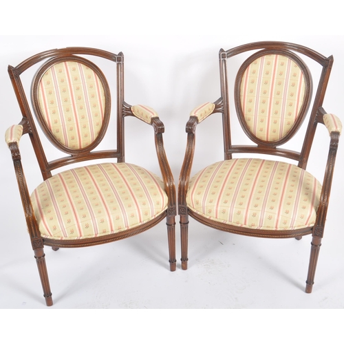 118 - A pair of 20th Century Edwardian mahogany armchairs / armchairs having carved show wood frames with ... 