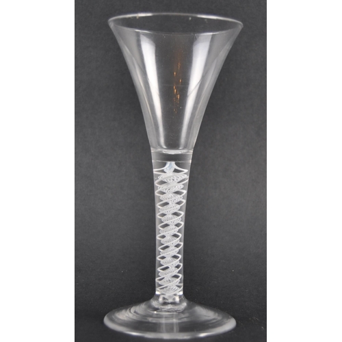 122 - A double series wine drinking glass having a trumpet shaped bowl with white opaque double series air... 