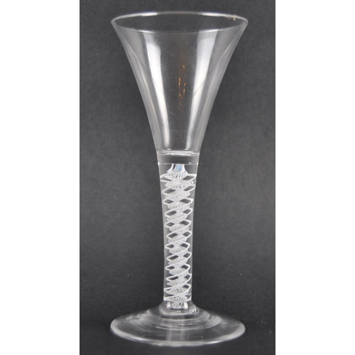 122 - A double series wine drinking glass having a trumpet shaped bowl with white opaque double series air... 