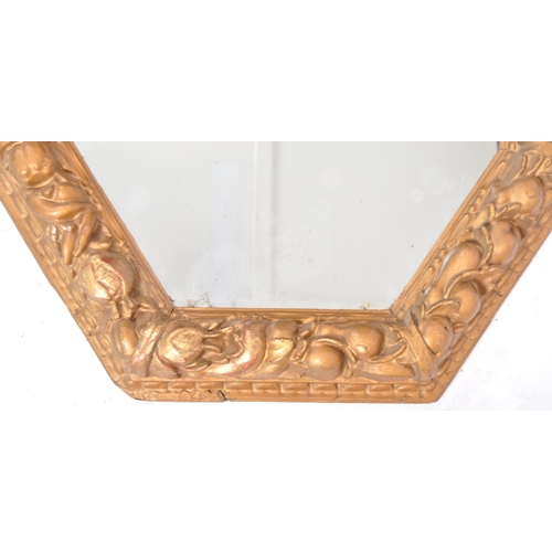 123 - An 18th Century gilt gesso framed wall mirror of octagonal form. Carved floral and fruit moulded fra... 