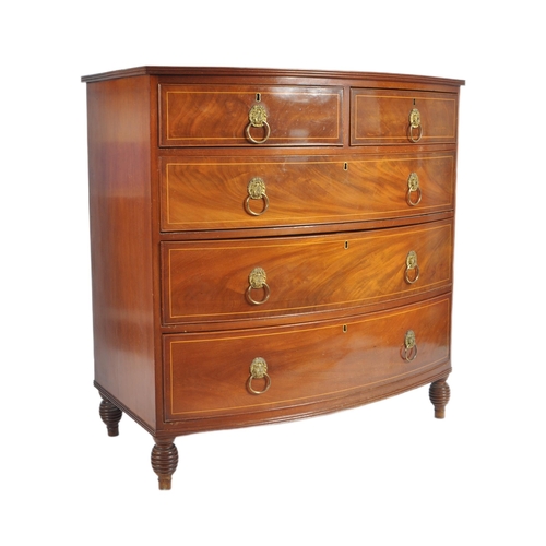 124 - An early 19th Century George III mahogany inlaid bow fronted chest of drawers. The bank of two over ... 