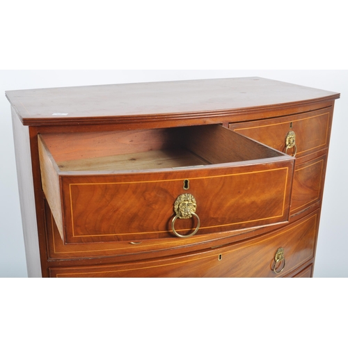 124 - An early 19th Century George III mahogany inlaid bow fronted chest of drawers. The bank of two over ... 