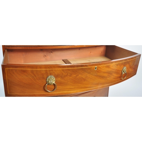 124 - An early 19th Century George III mahogany inlaid bow fronted chest of drawers. The bank of two over ... 