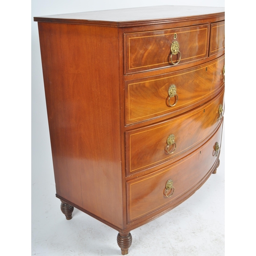 124 - An early 19th Century George III mahogany inlaid bow fronted chest of drawers. The bank of two over ... 