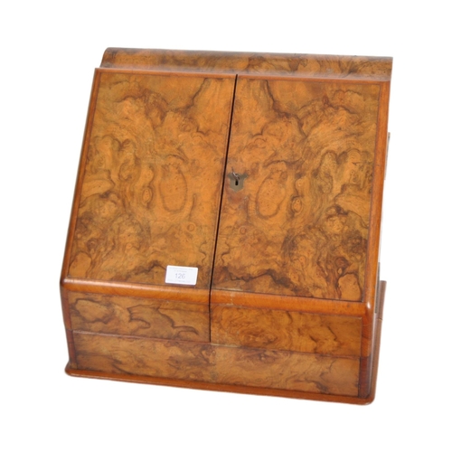 126 - A 19th Century figured walnut desk tidy stationery box compendium. Twin doors opening to reveal a fu... 