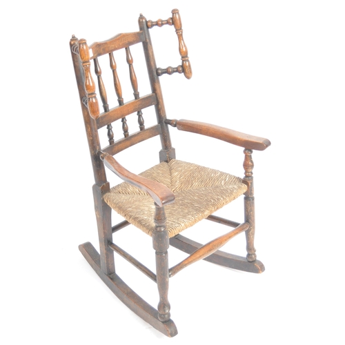 127 - A 19th Century Lancashire / North Country oak childs rocking chair with spindle back and wings havin... 