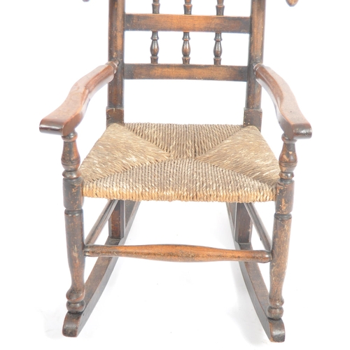 127 - A 19th Century Lancashire / North Country oak childs rocking chair with spindle back and wings havin... 